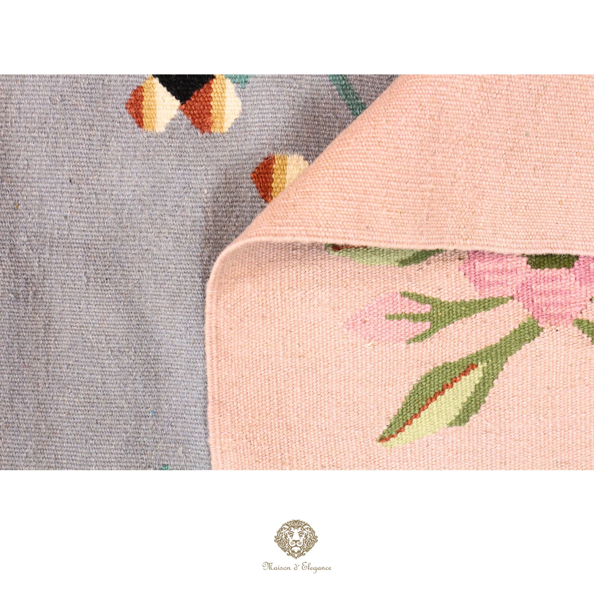 Close-up of a floral-patterned fabric with a brand logo in the corner.