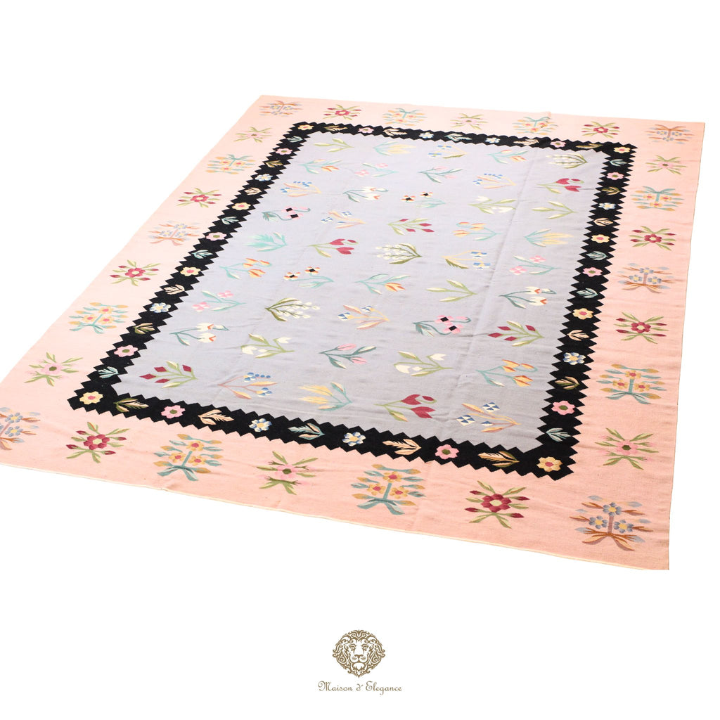 Quilt with floral border on a blue background