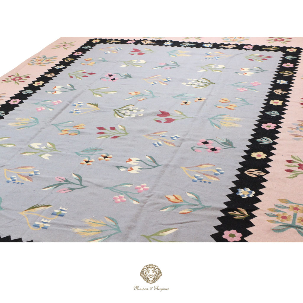 Decorative European rug with floral border on a gray background