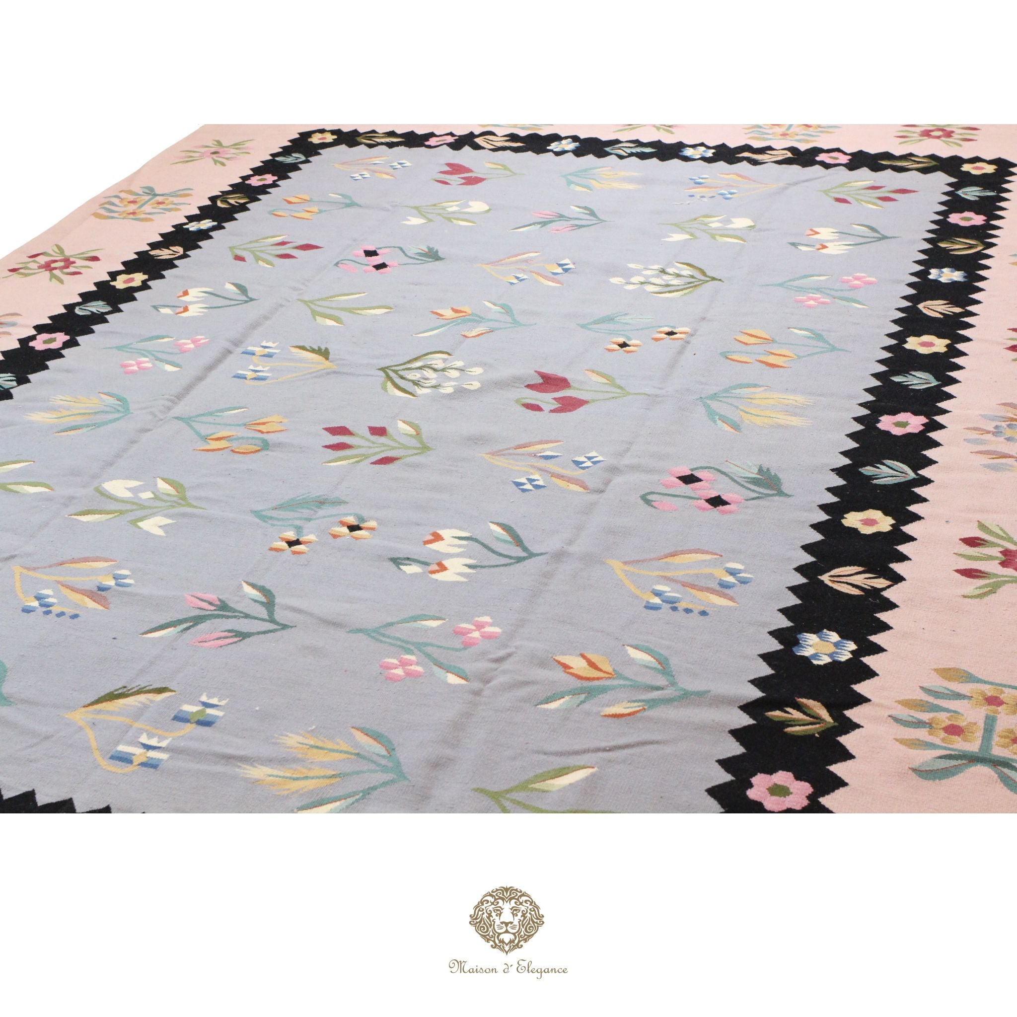 Decorative European rug with floral border on a gray background