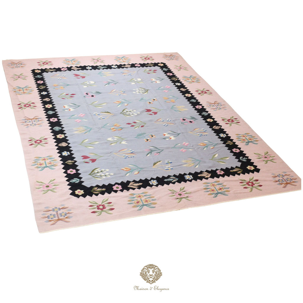 Decorative European rug with floral border on a gray background