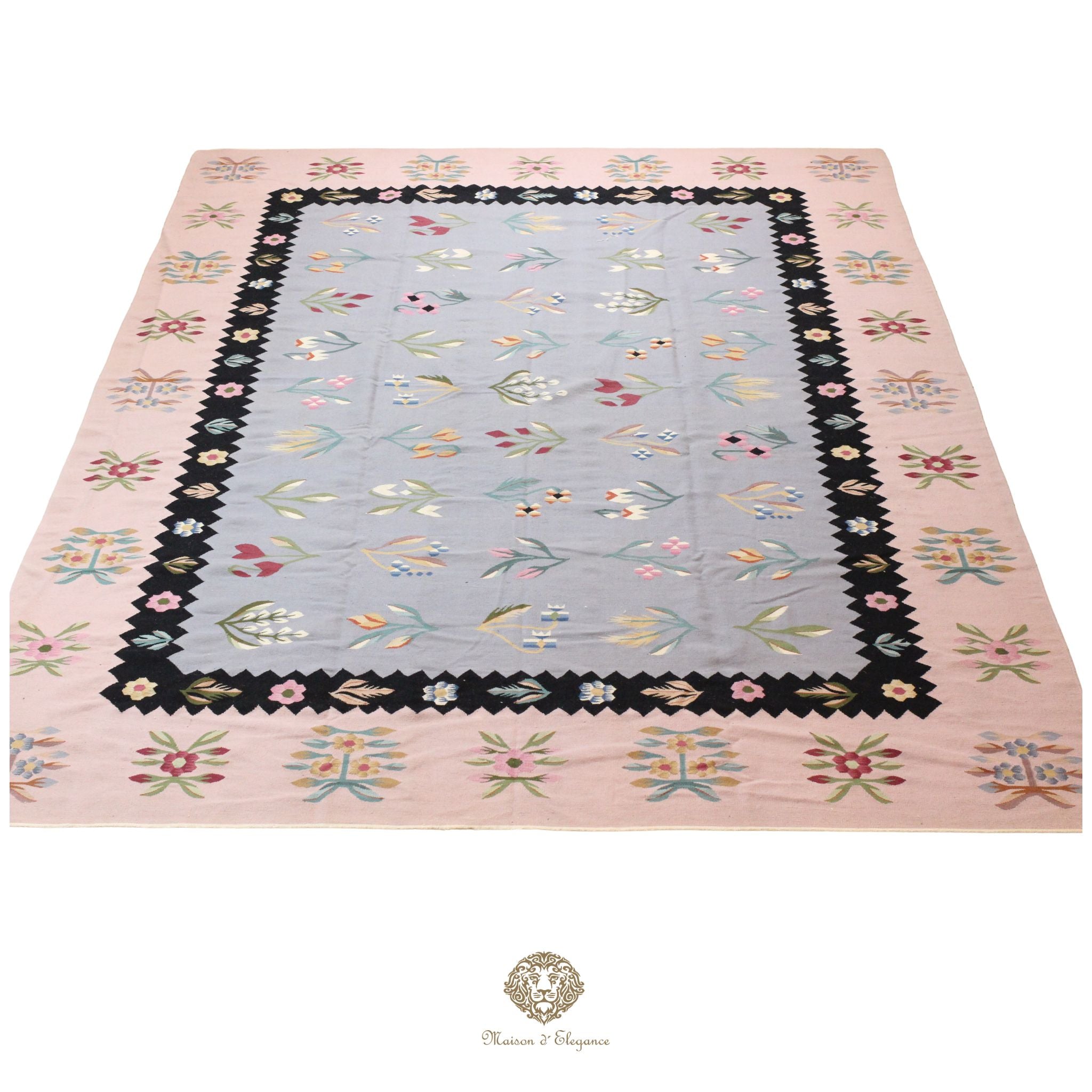 Decorative European rug with floral border on a gray background