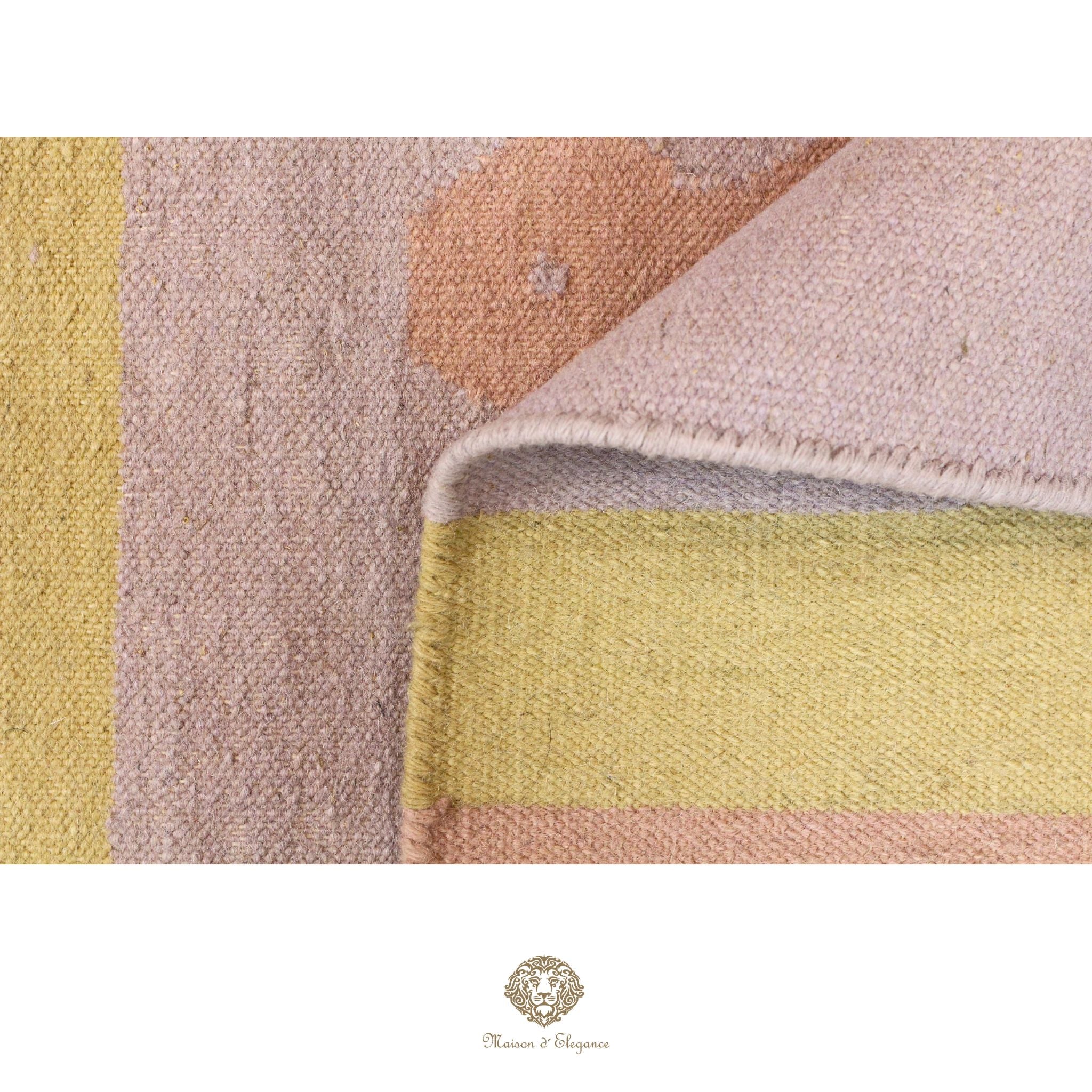Close-up of a textured fabric with geometric pattern in soft colors, featuring a brand logo at the bottom.