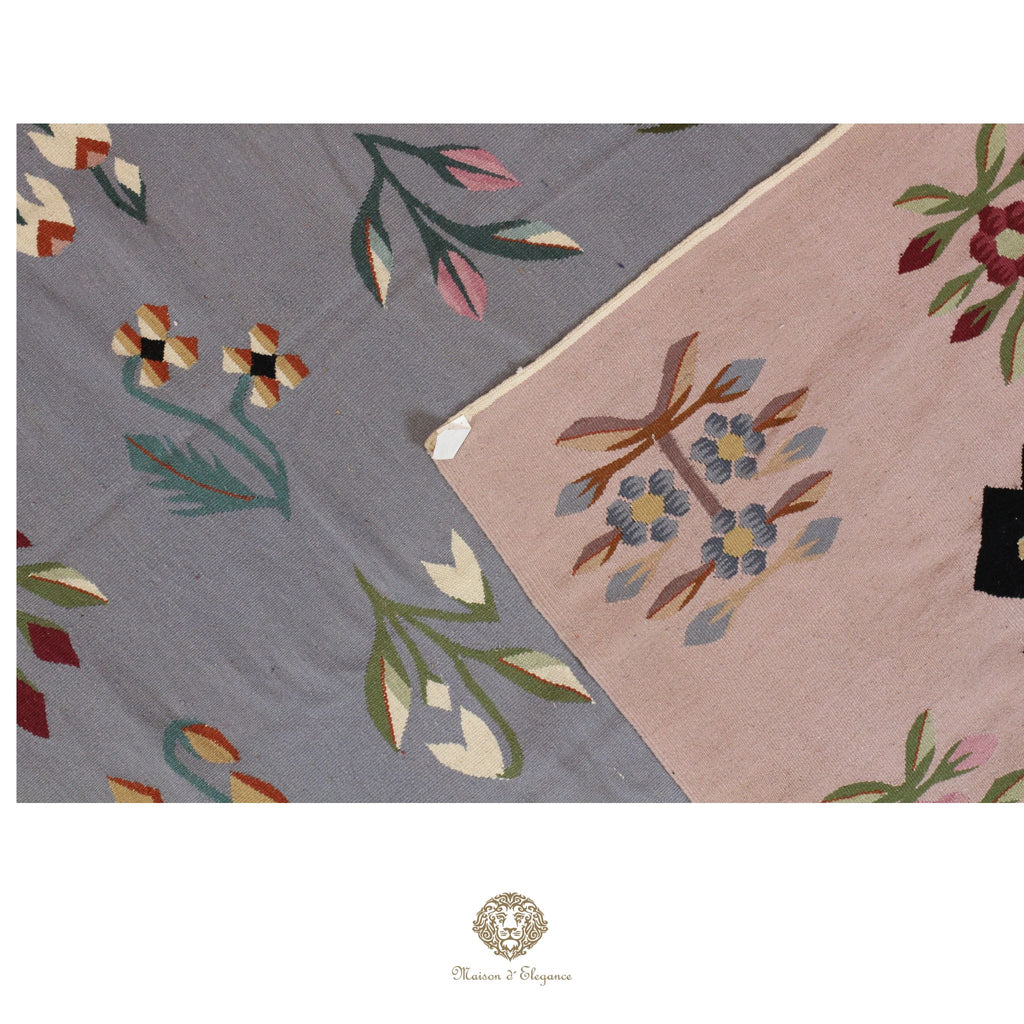 Two floral-patterned rugs on a white background with a brand logo at the bottom.