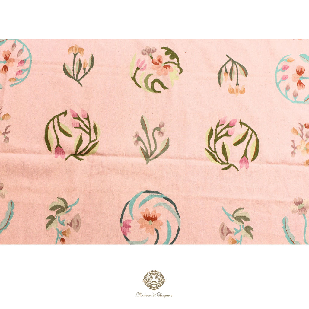 Patterned fabric with floral designs on a pink background