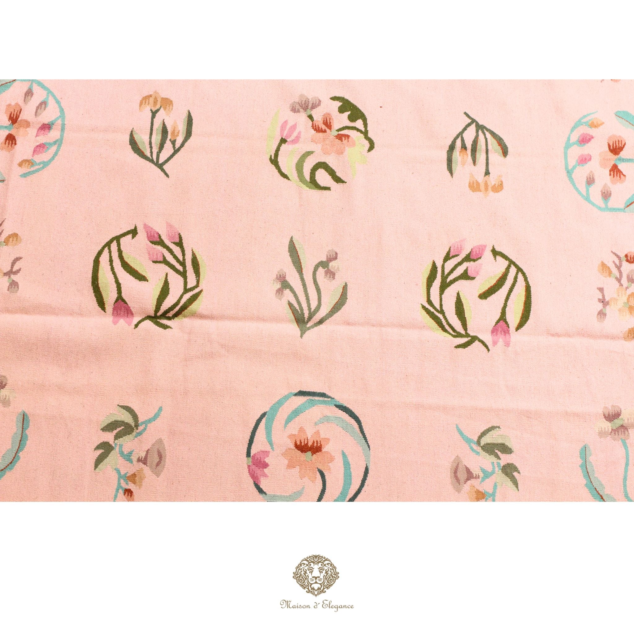 Patterned fabric with floral designs on a pink background