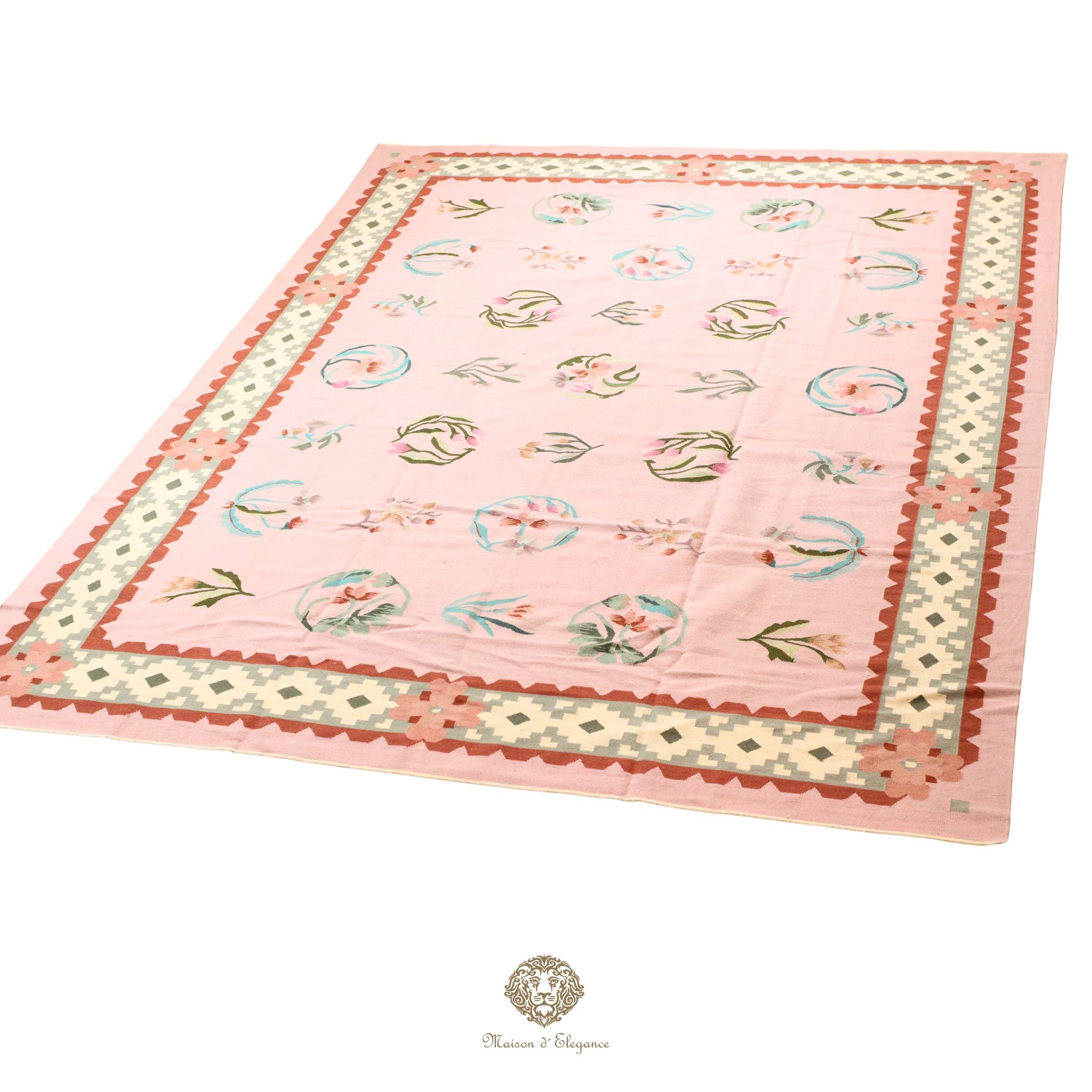 Pink quilt with floral patterns on a pink background