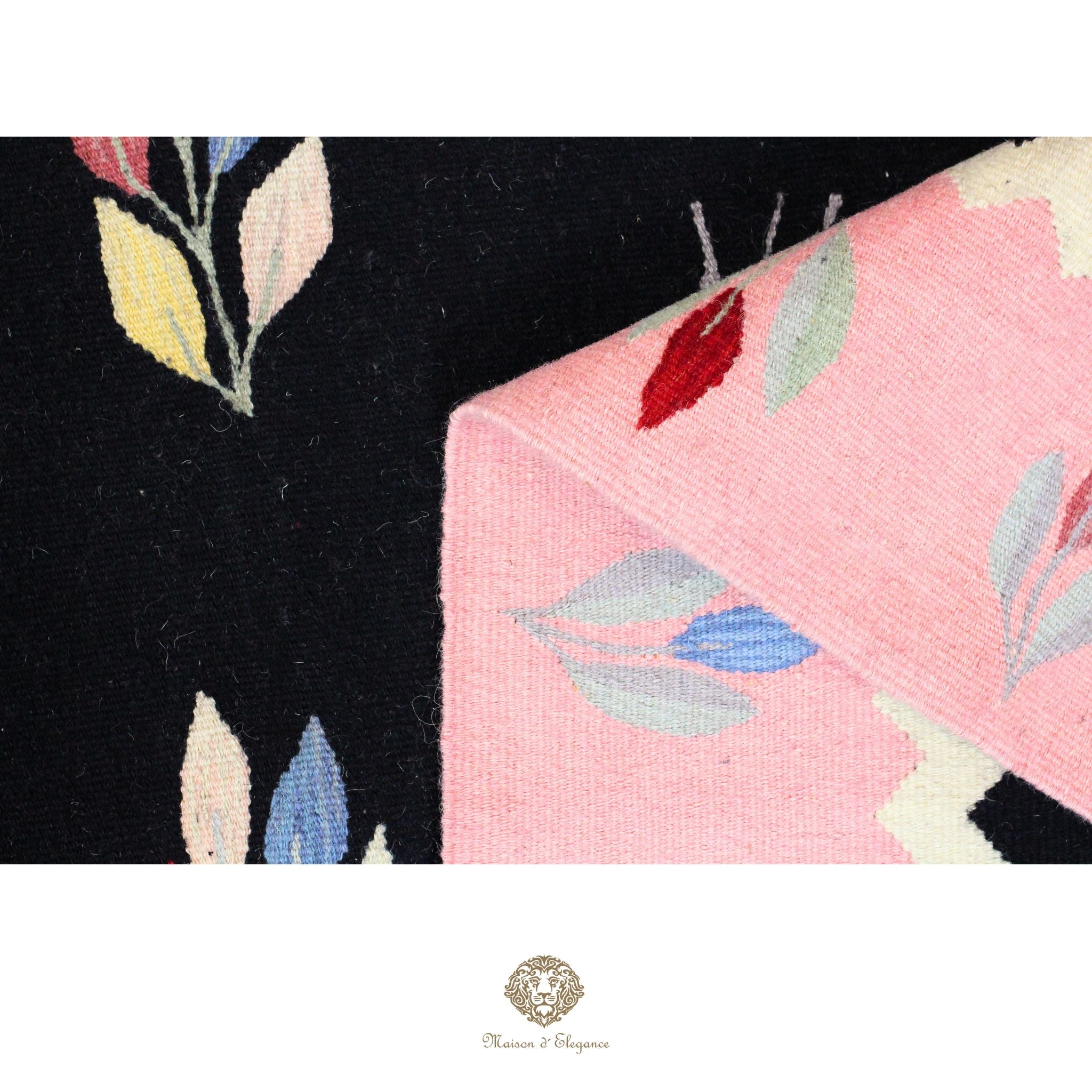 Close-up of a floral-patterned fabric with black, pink, and multicolor leaves on a black background.