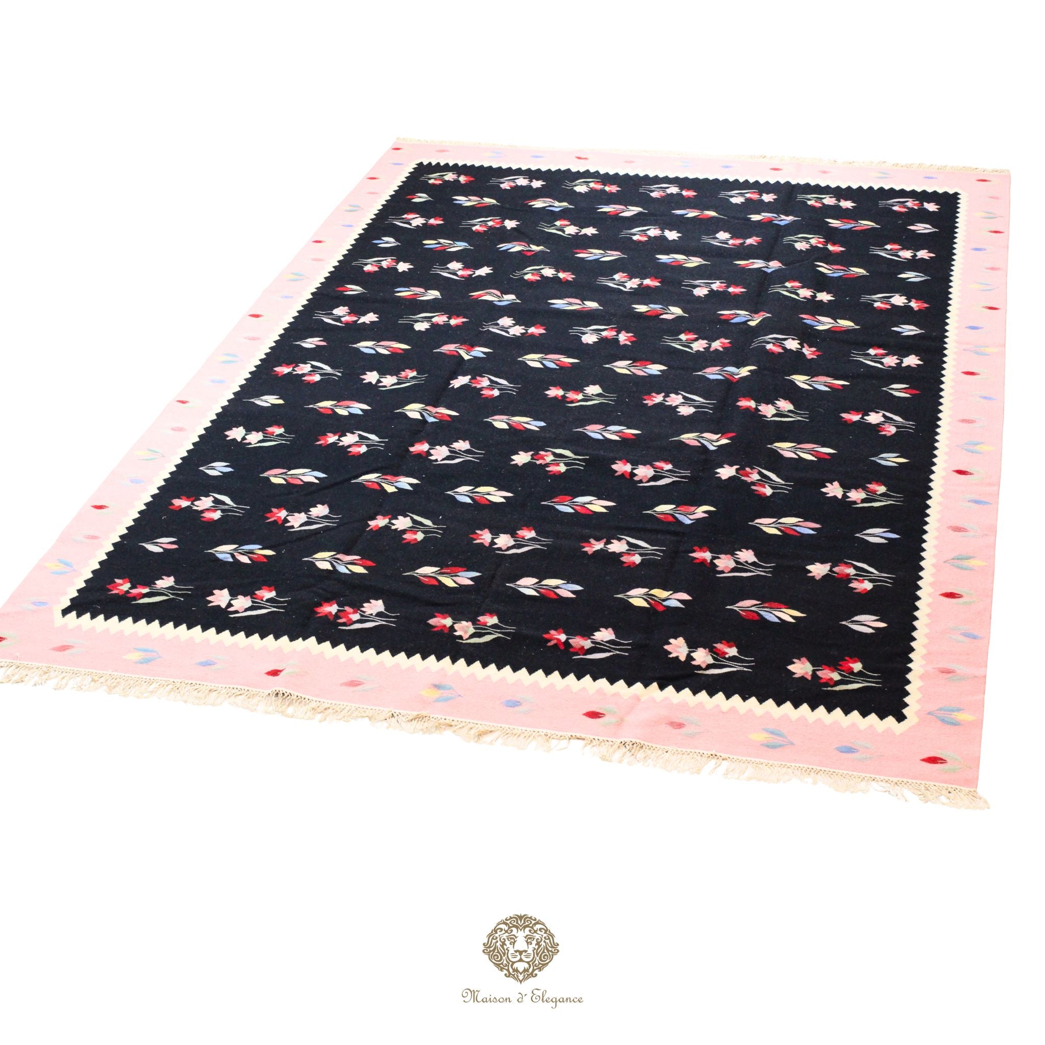 Black fabric swatch with pink border and floral pattern on a black background
