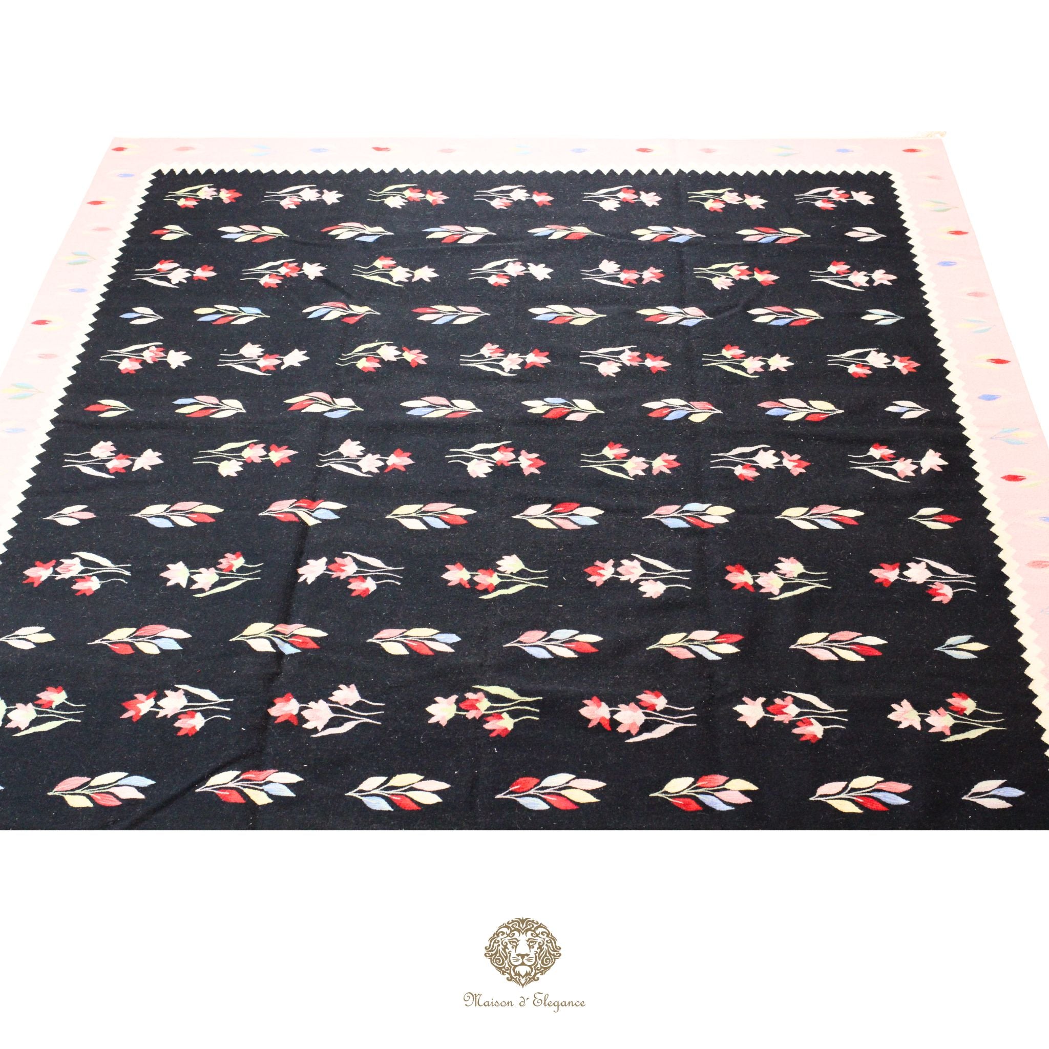 Floral patterned fabric on a black background with a visible brand logo.
