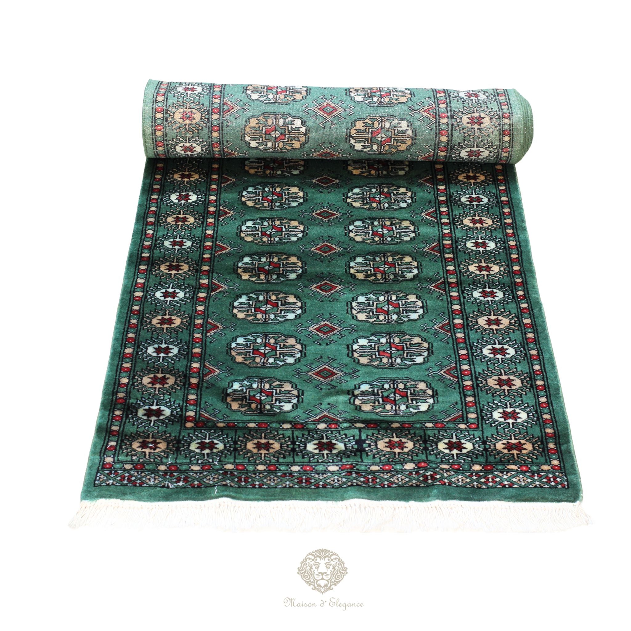 Roll of patterned teal rug on a white background
