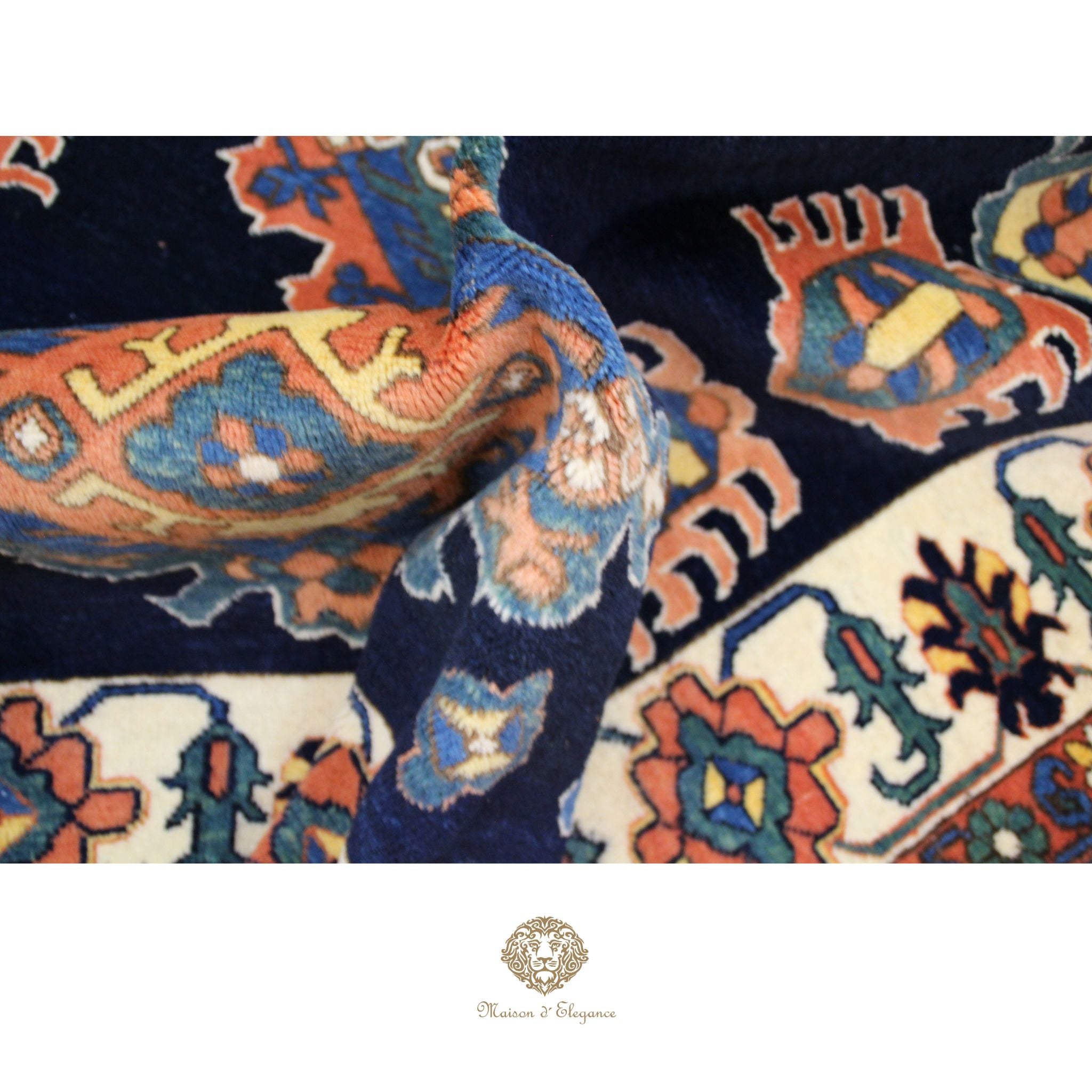 Close-up of a patterned fabric with intricate designs in navy blue, orange, and white.