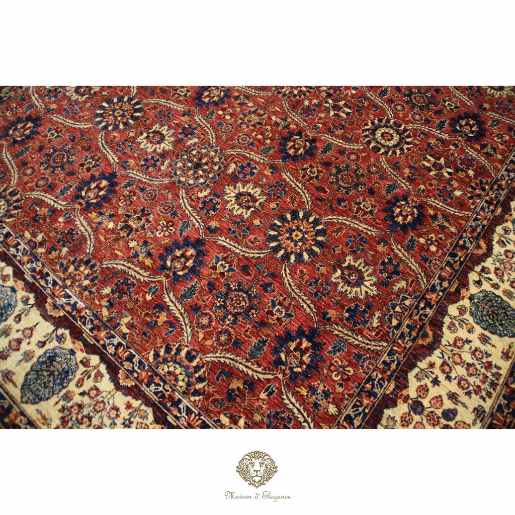 Close-up of a patterned rug with intricate designs on a red background