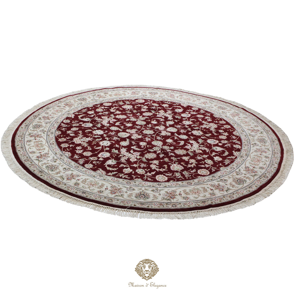 Round red and beige patterned rug on a red background