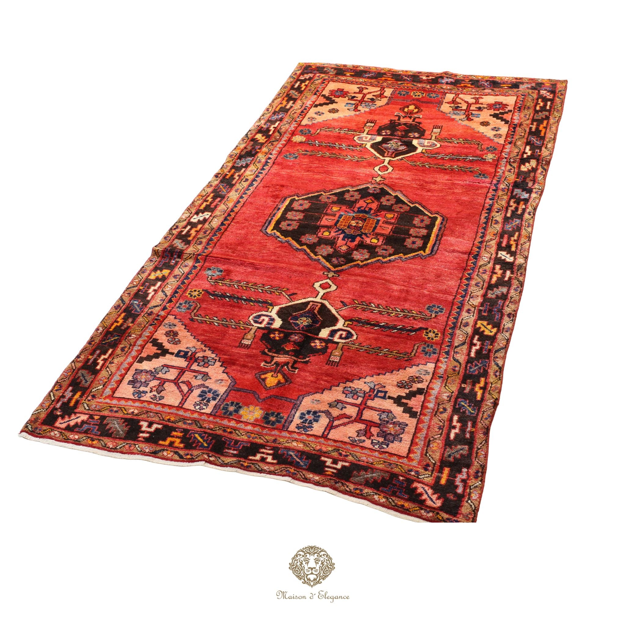 Decorative red rug with intricate patterns on a white background