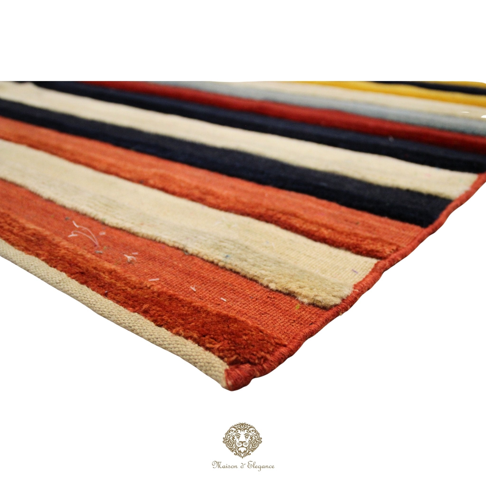 Striped rug with orange, beige, black, and yellow colors on a white background.