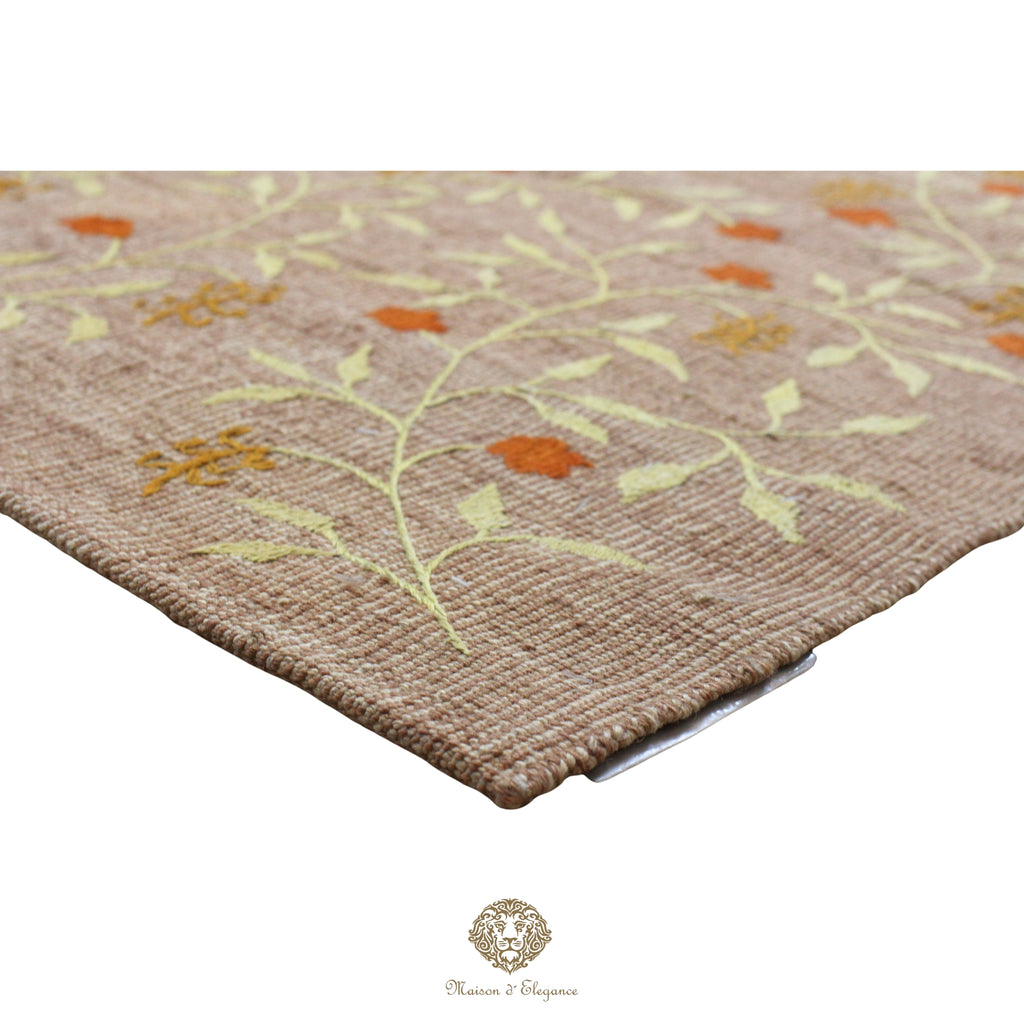 Close-up of a textured rug with floral patterns on a khaki background