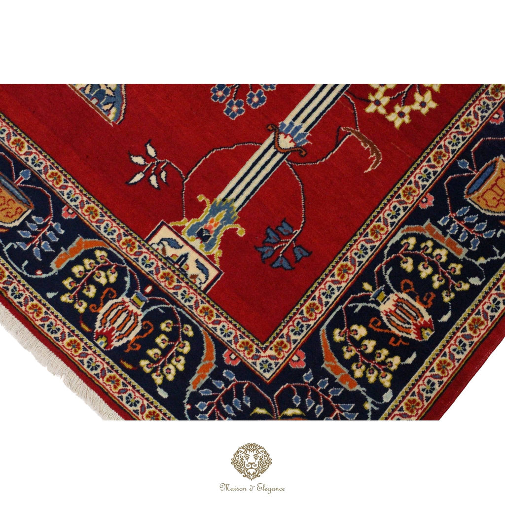 Close-up of a red and blue patterned rug with intricate designs.