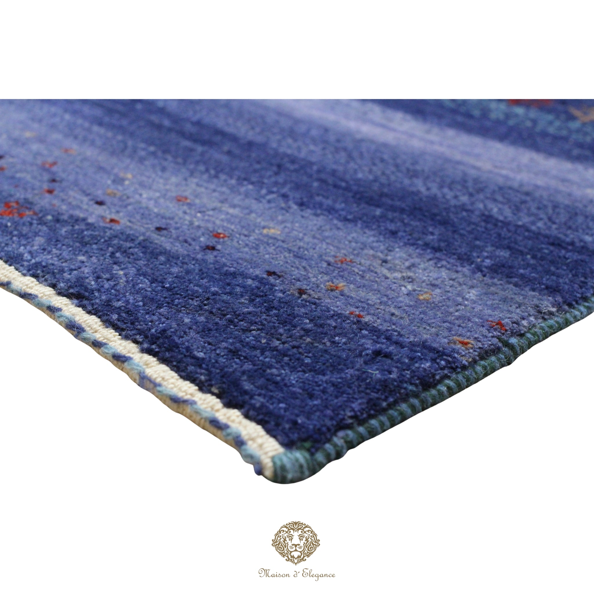 Blue textured rug with a brand logo in the corner