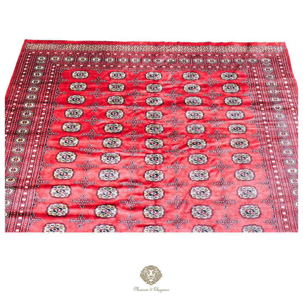 Red patterned fabric with intricate designs on a red background