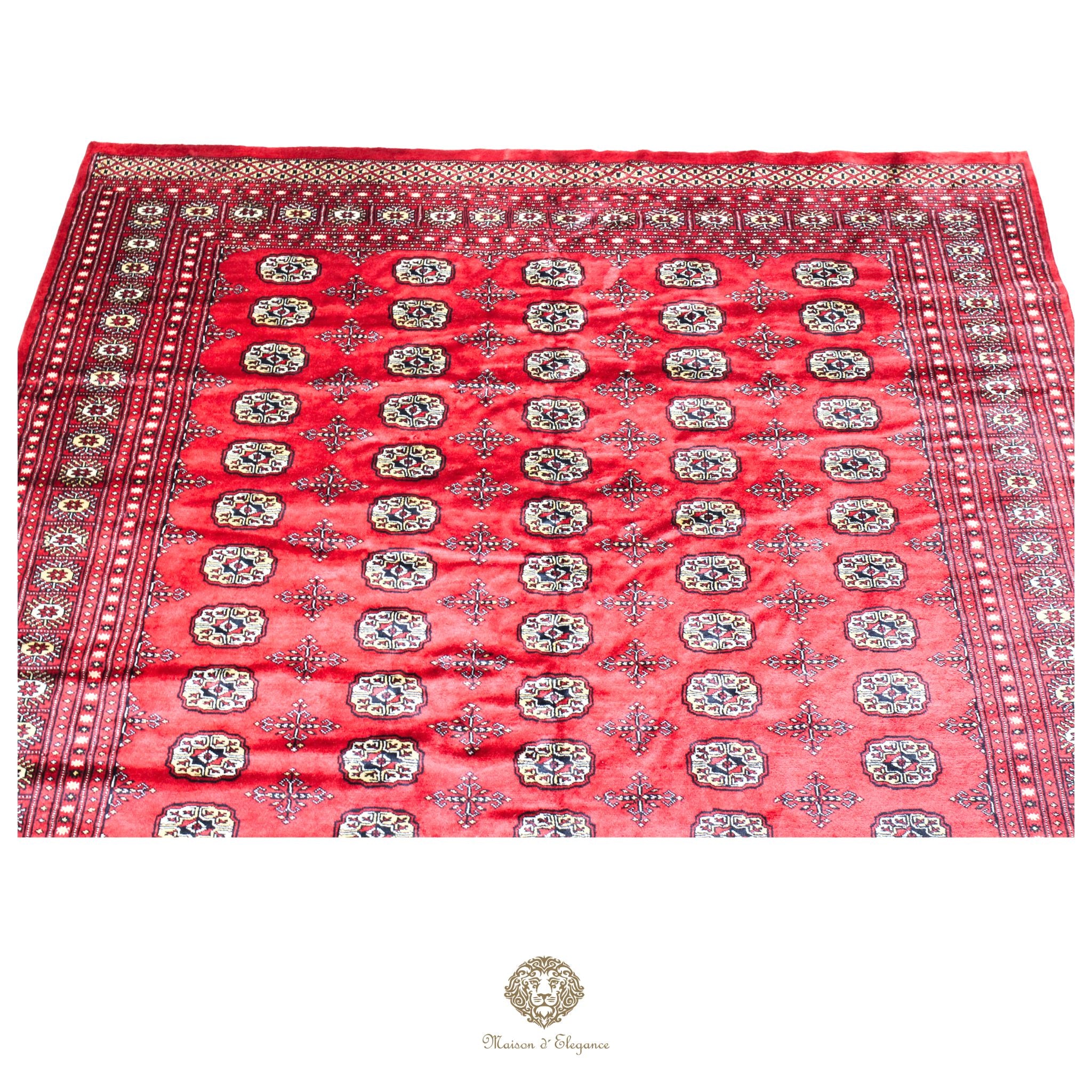 Red patterned fabric with intricate designs on a red background