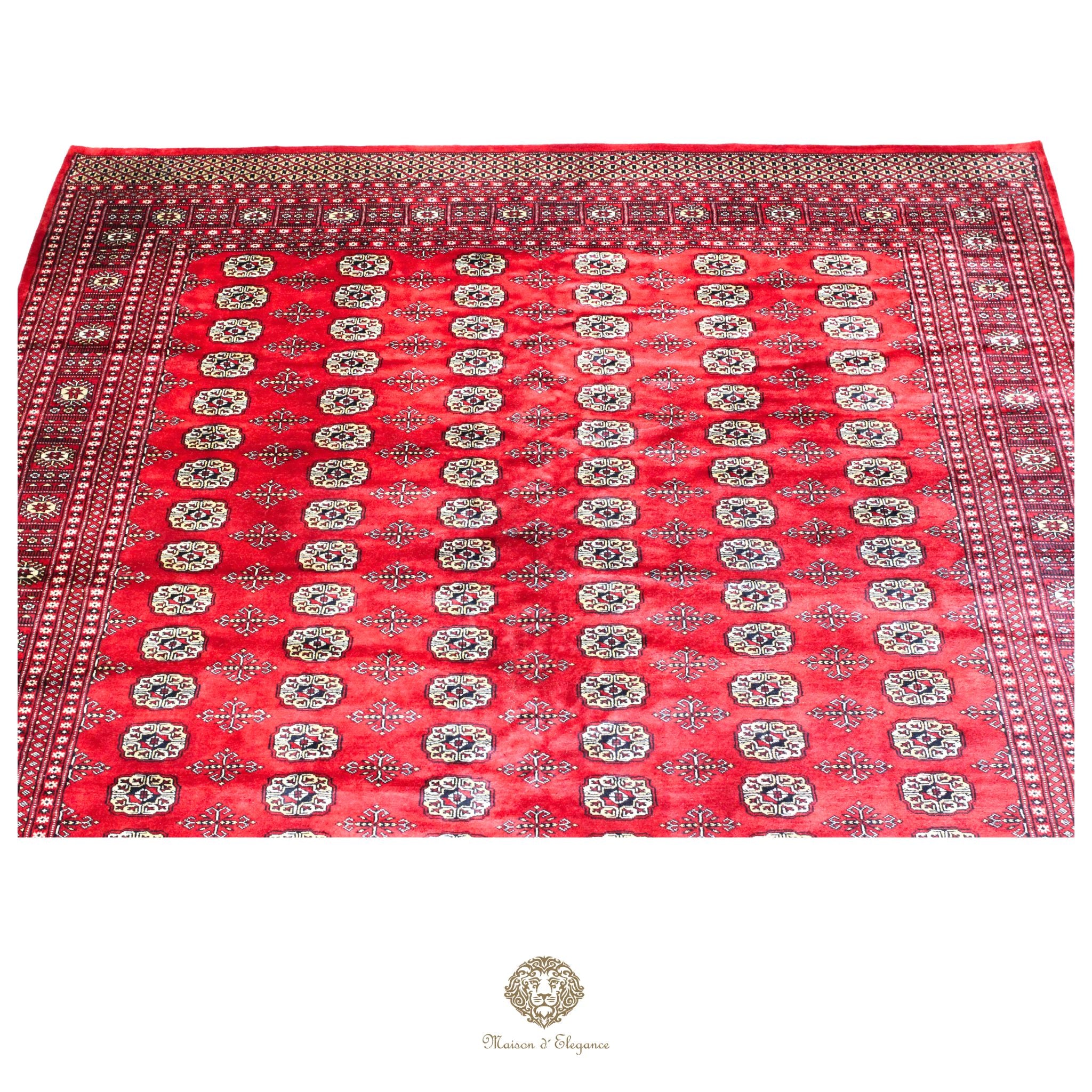 Red patterned fabric with a brand logo at the bottom right corner on a red background