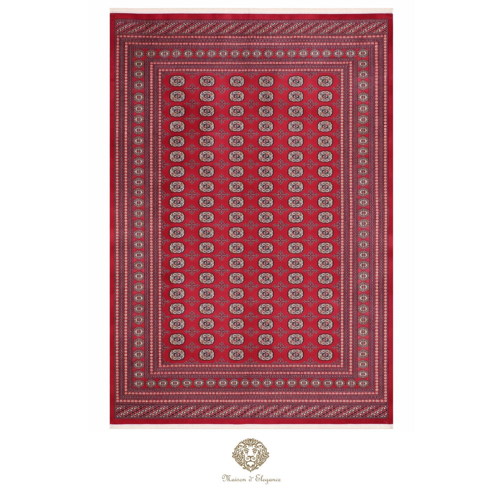 Red patterned rug with a brand logo at the bottom center on a white background
