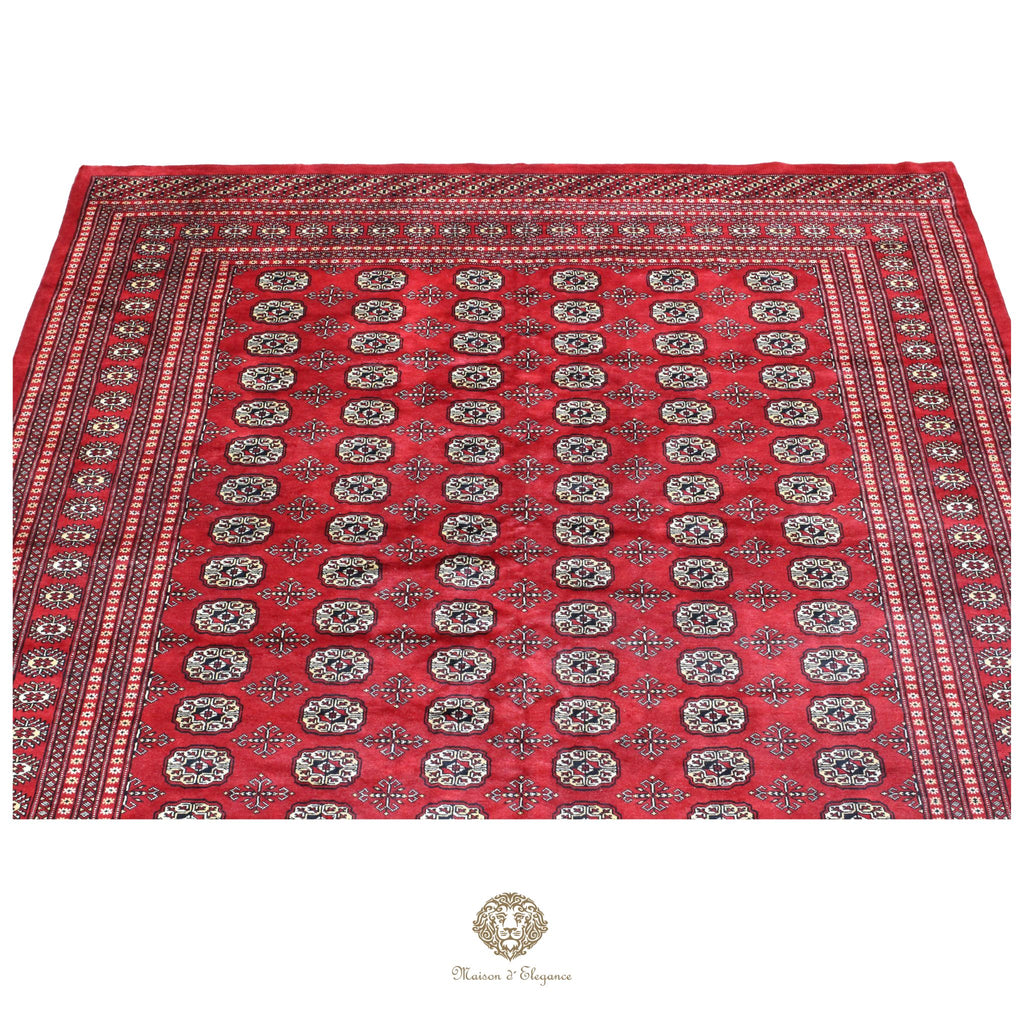 Red patterned fabric with intricate designs on a white background