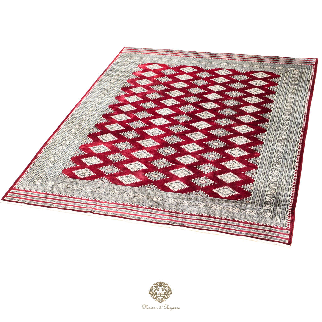 Red and white patterned rug with a geometric design on a red background