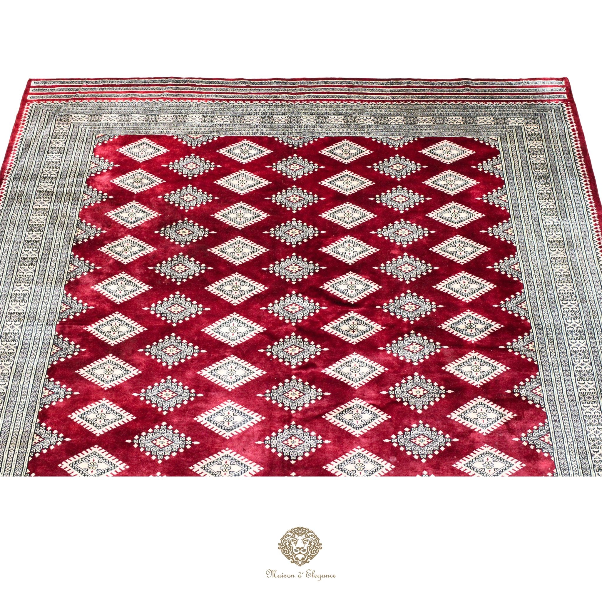 Decorative rug with red and gray geometric pattern on a red background