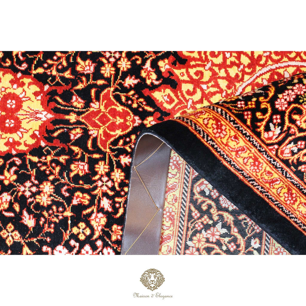 Close-up of a patterned rug with intricate designs on a black background