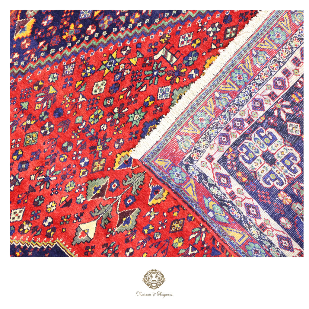 Two patterned rugs with vibrant colors and intricate designs, one red and the other multicolored, on a red background.