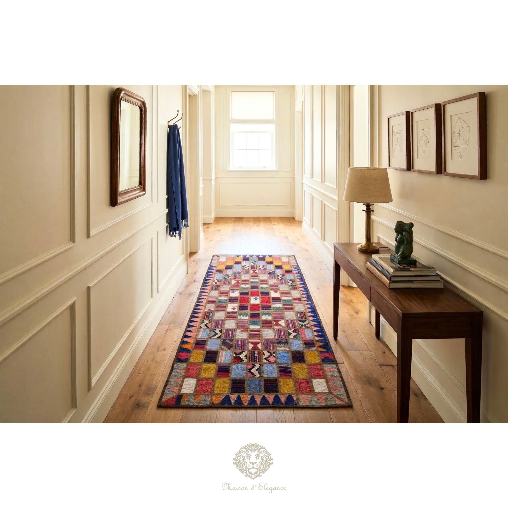 Colorful geometric-patterned rug on a wooden floor in a well-lit hallway with a lamp and books on a table.