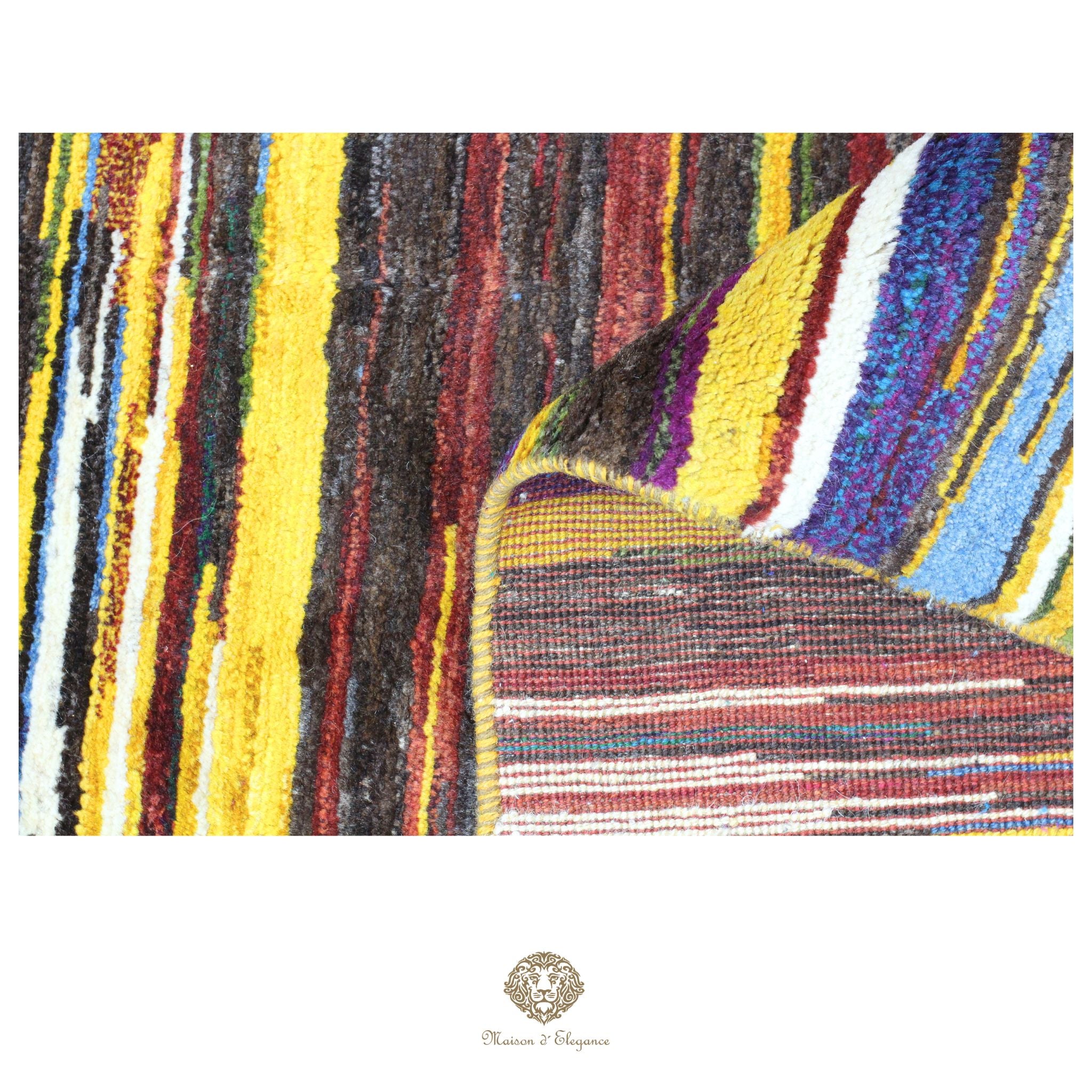 Close-up of a colorful textured fabric with a brand logo at the bottom.