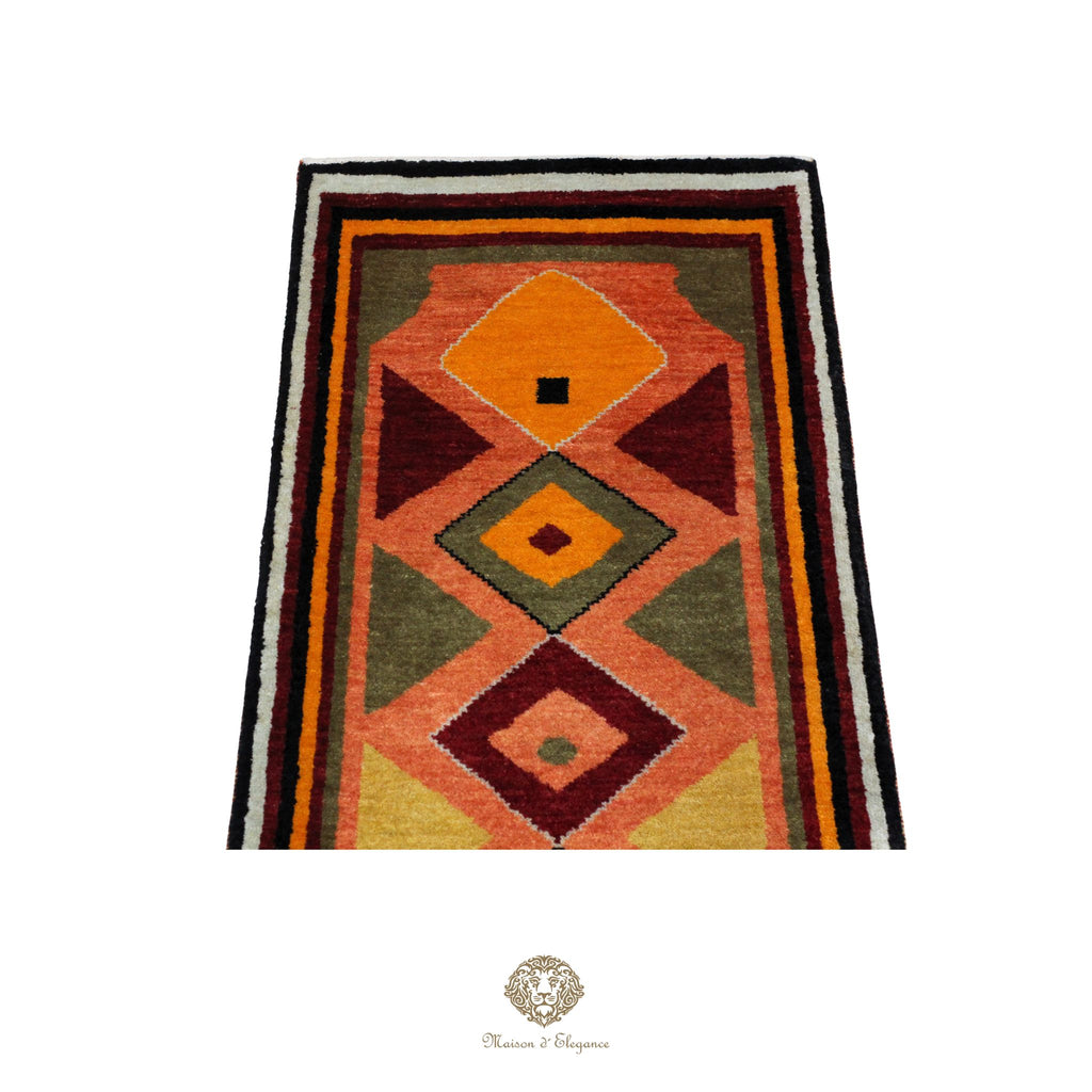 Geometric patterned rug with orange, green, and brown colors on a orange background