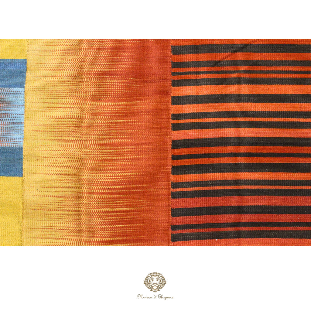 Colorful ribbon with blue, yellow, orange, and black stripes on a colorful background