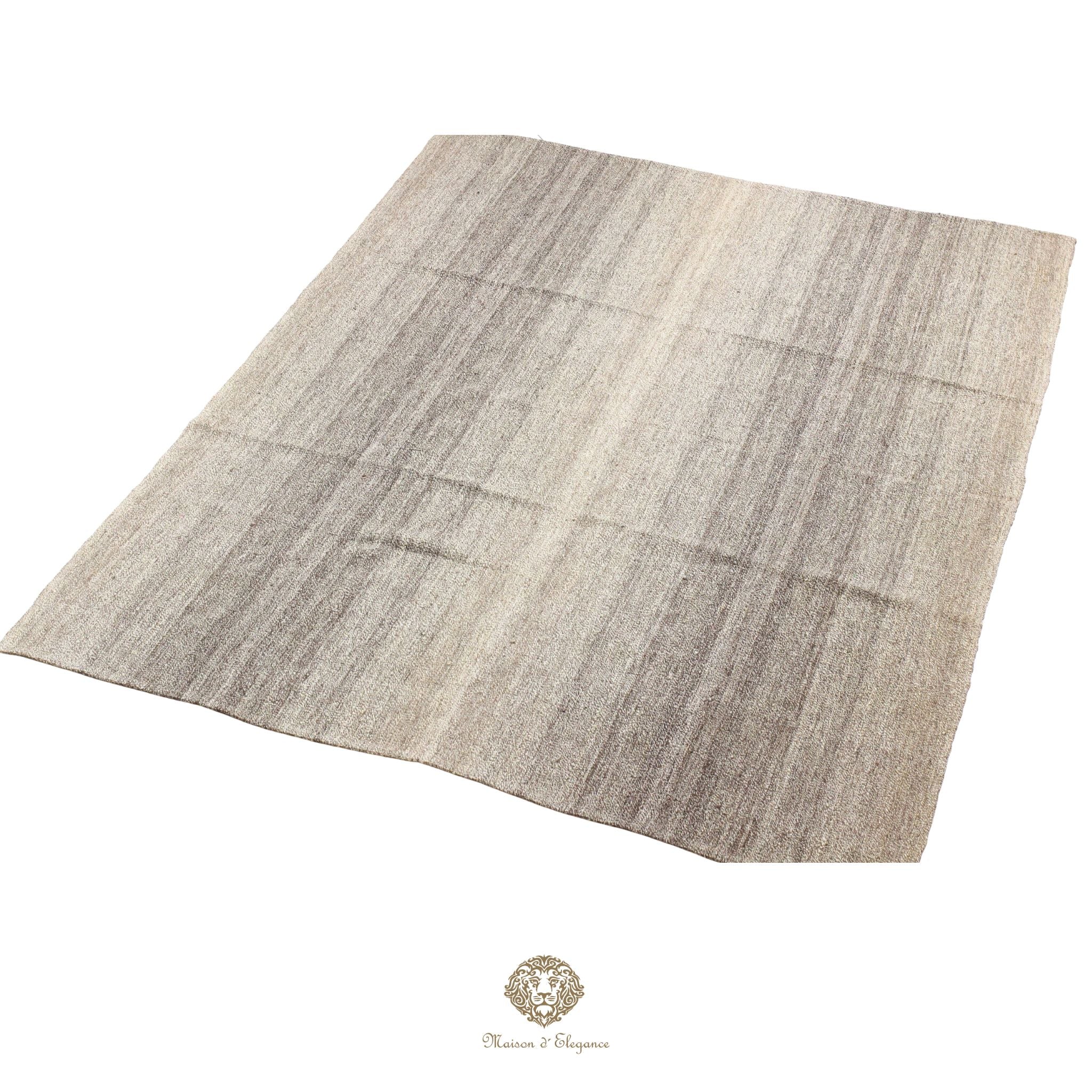 Rectangular rug with a grid pattern on a gray background