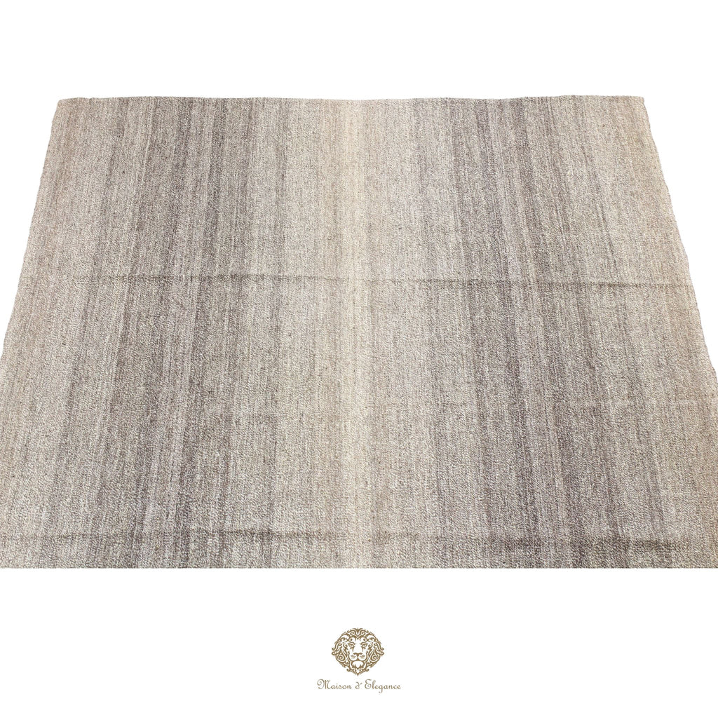 Textured fabric swatch in gray and beige on a gray background