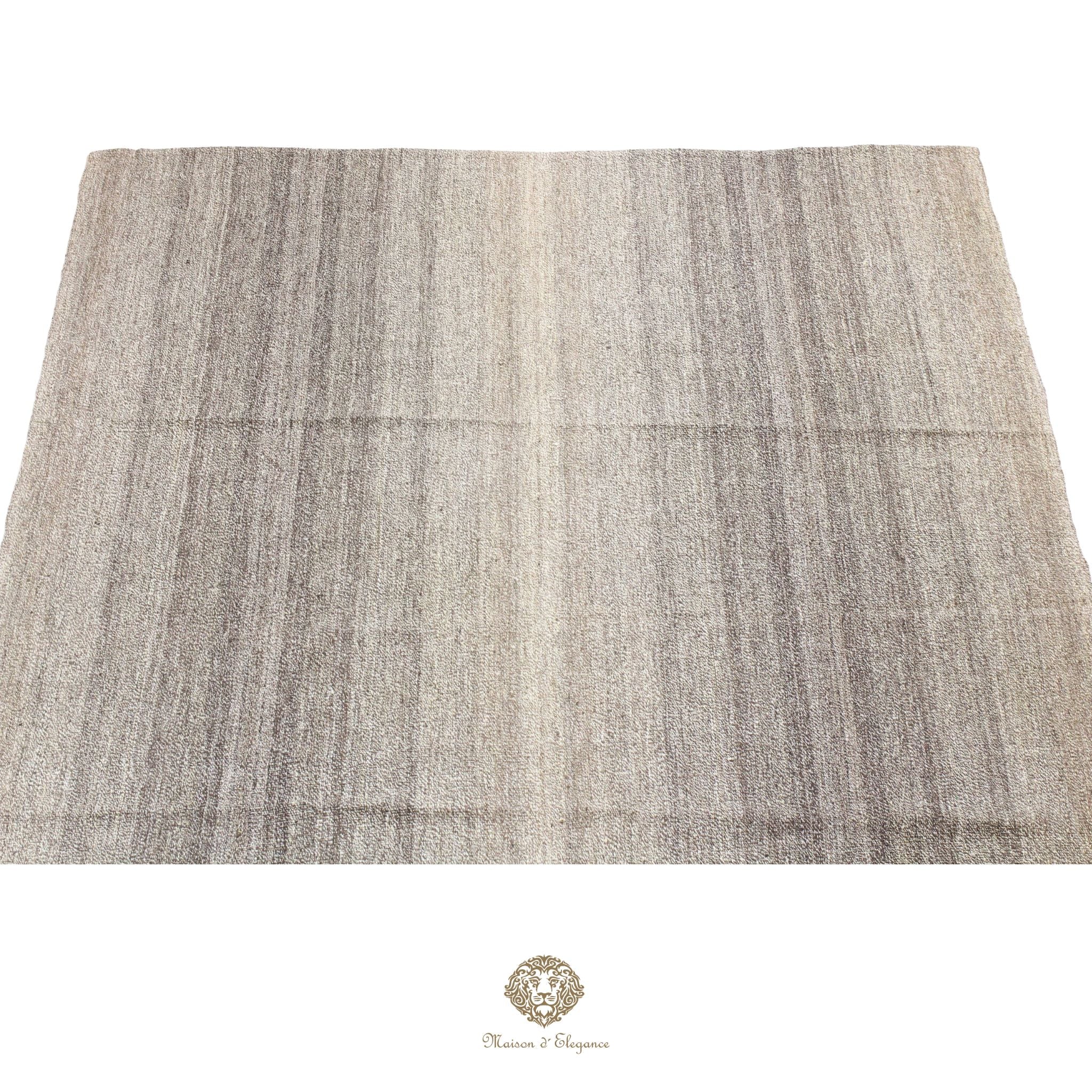 Textured fabric swatch in gray and beige on a gray background