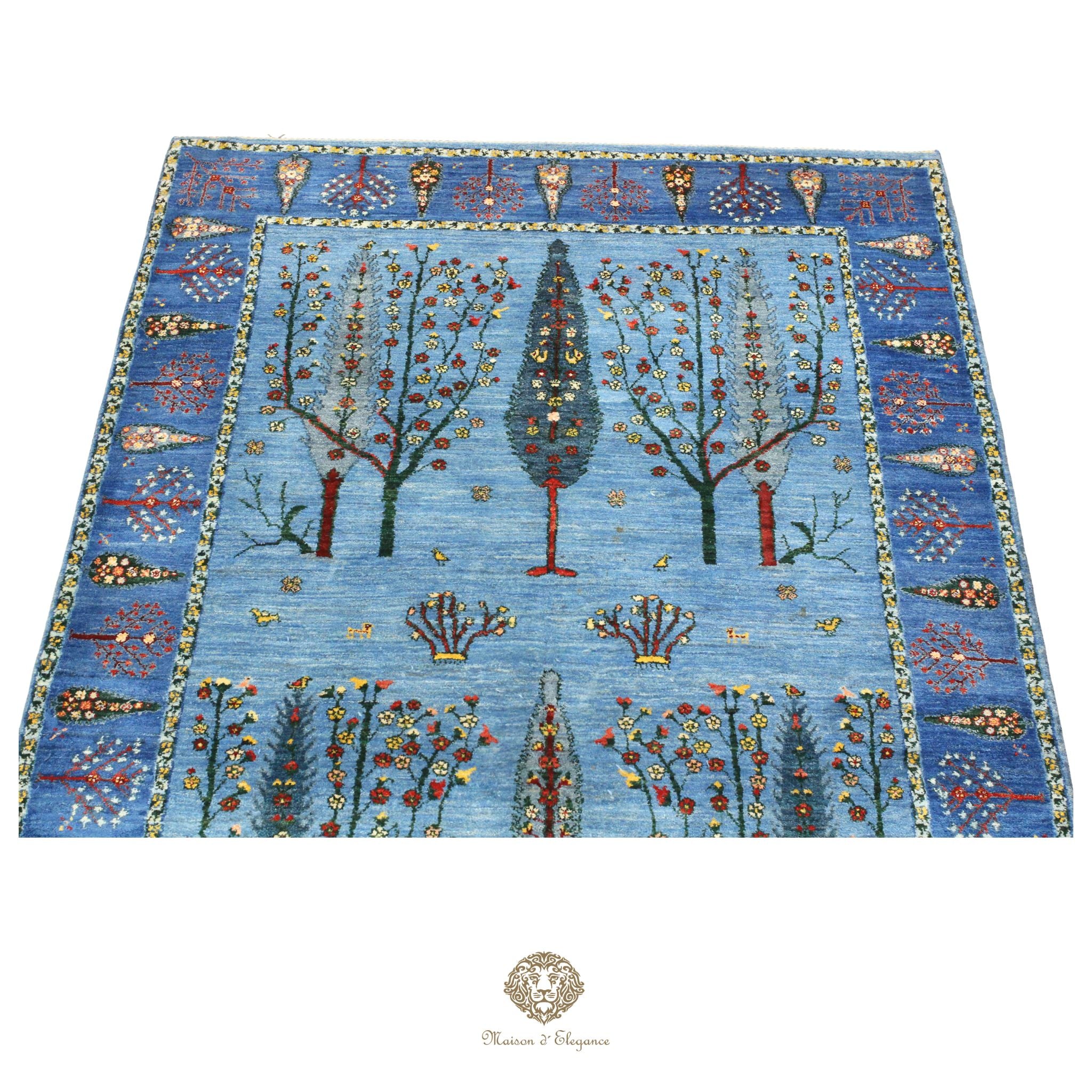 Decorative rug with tree and floral patterns on a blue background