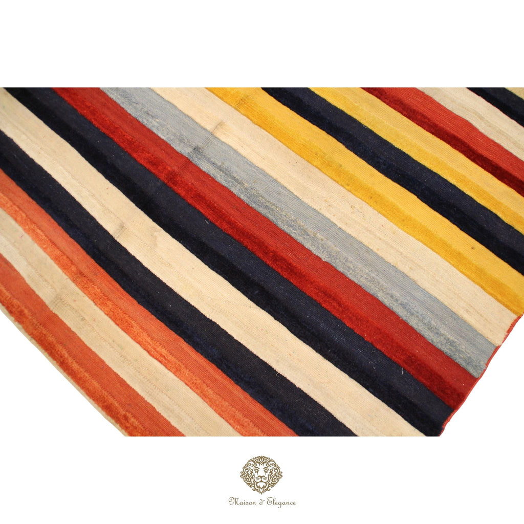 Striped rug with red, yellow, black, and beige colors on a white background.