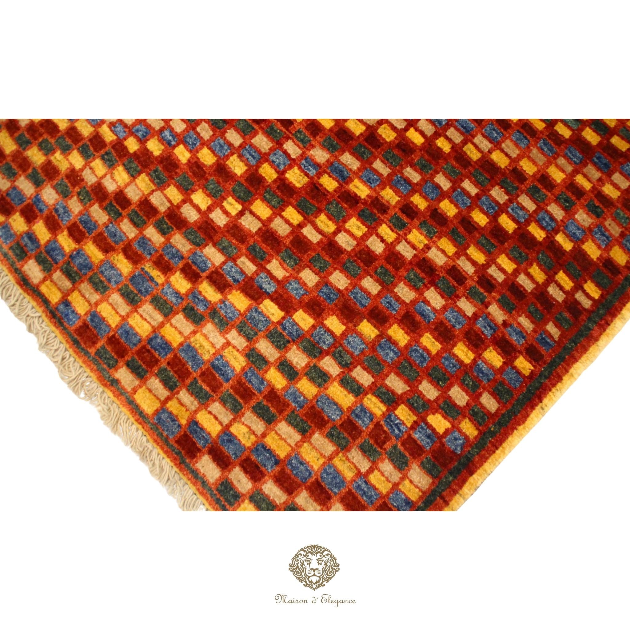 Patterned rug with a geometric design featuring red, orange, and blue colors on a red background.