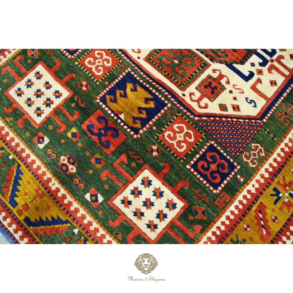 Colorful patterned rug with geometric designs on a Green background
