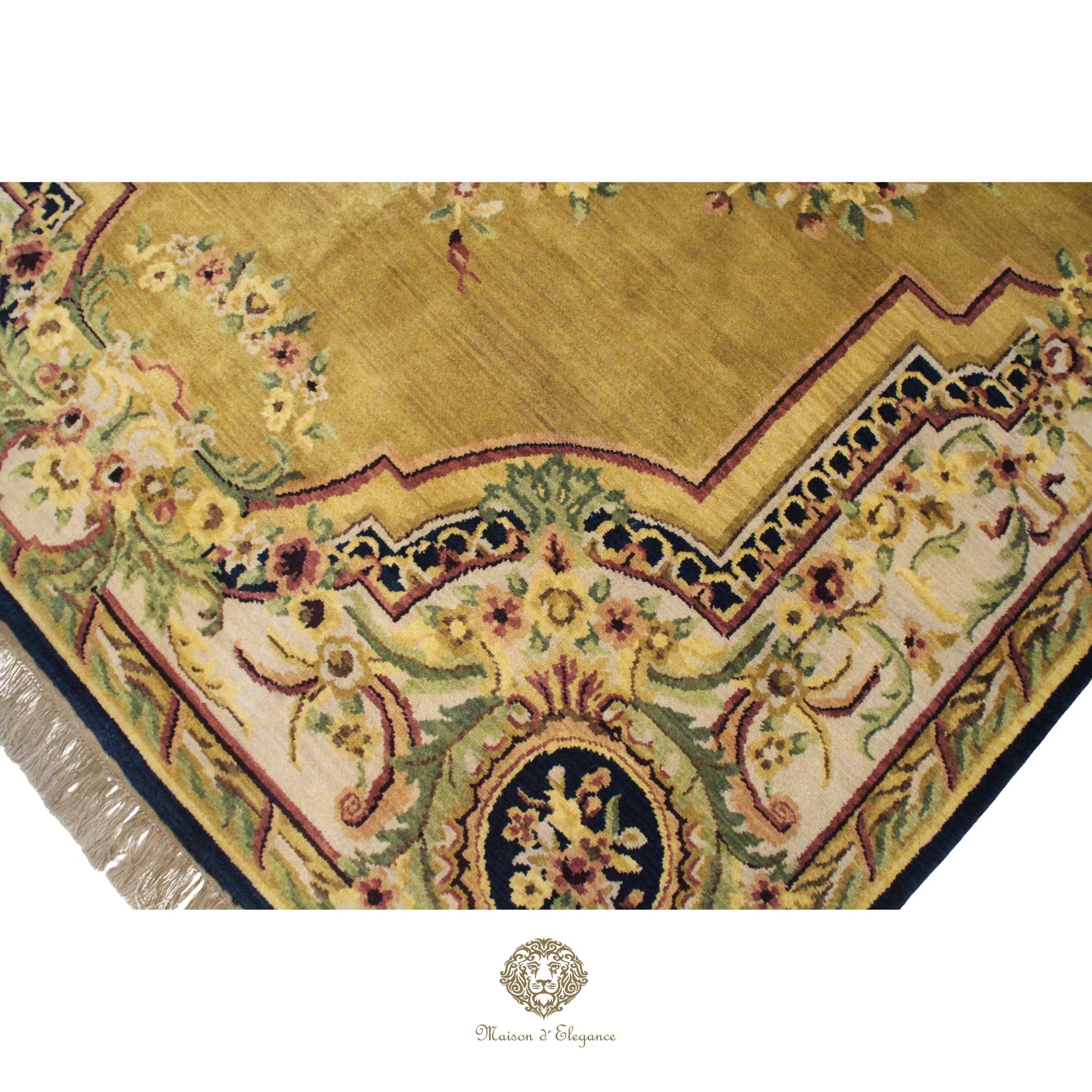 Decorative rug with floral patterns and a brand logo at the bottom.