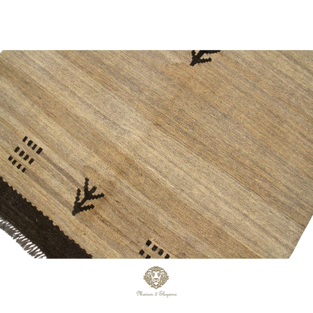 Textured brown rug with geometric patterns on a ivory background