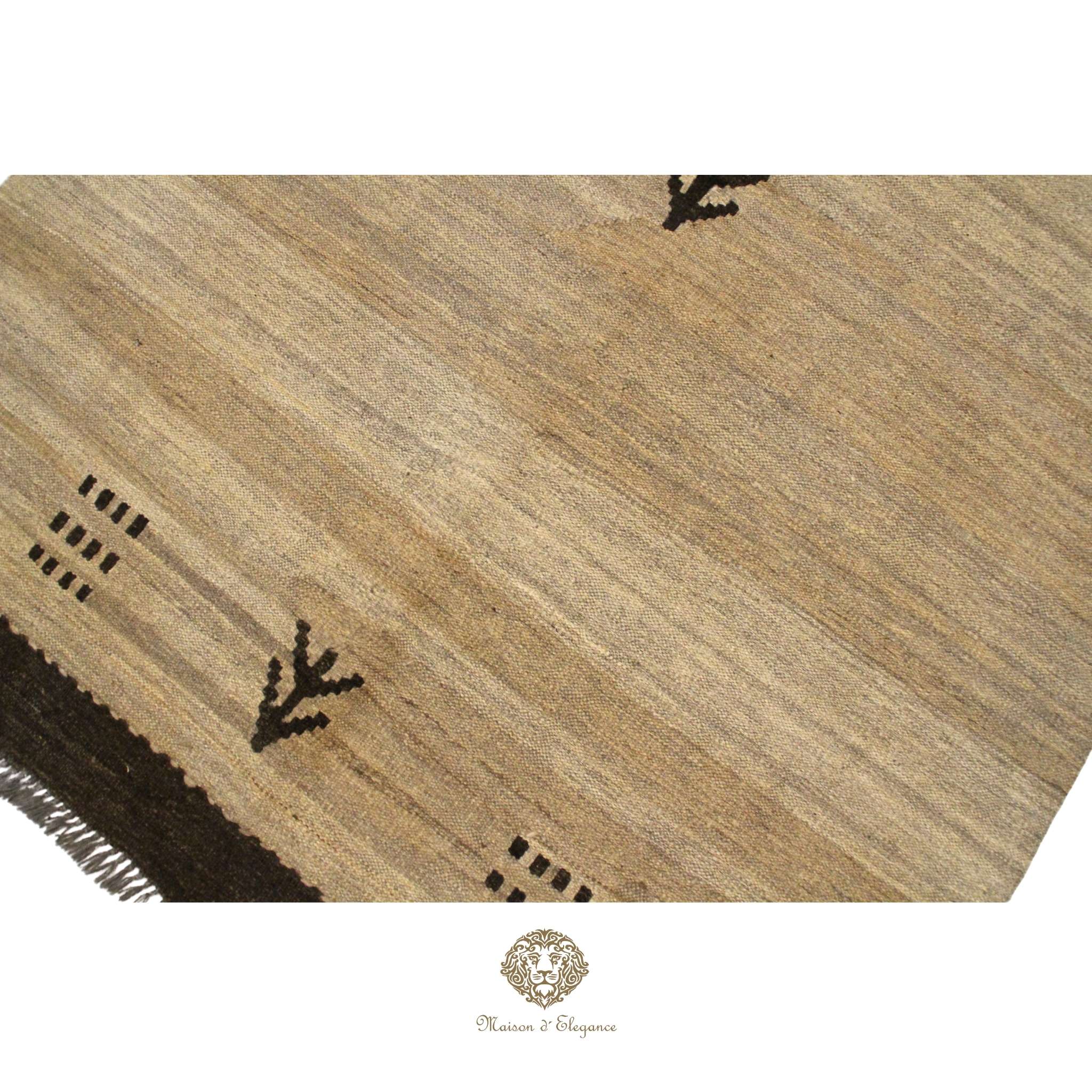 Textured brown rug with geometric patterns on a ivory background