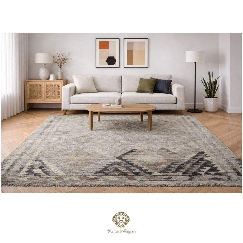 Living room with a patterned rug, sofa, coffee table, and decor items.