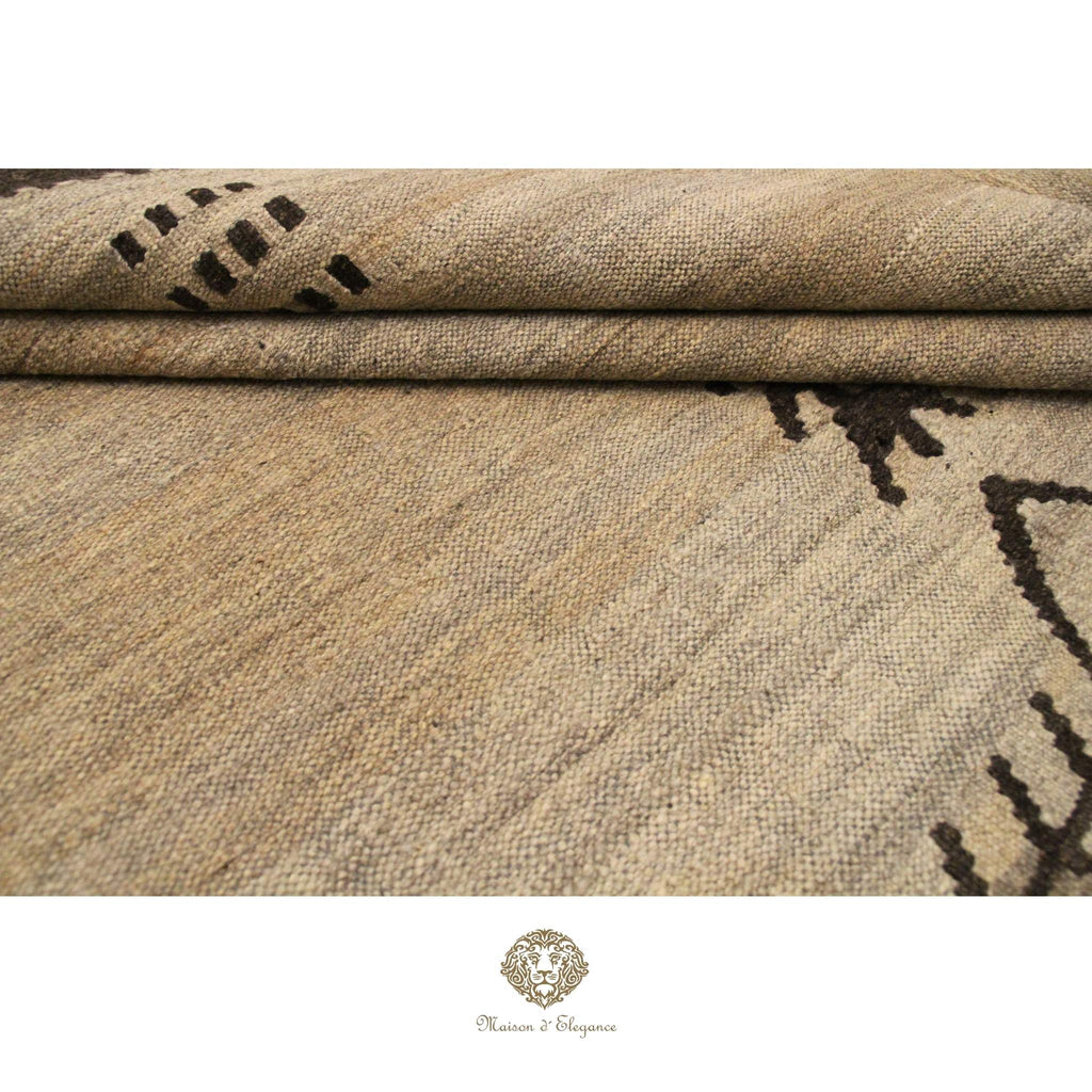 Textured fabric with black pattern, possibly a rug or textile sample, on a ivory background.