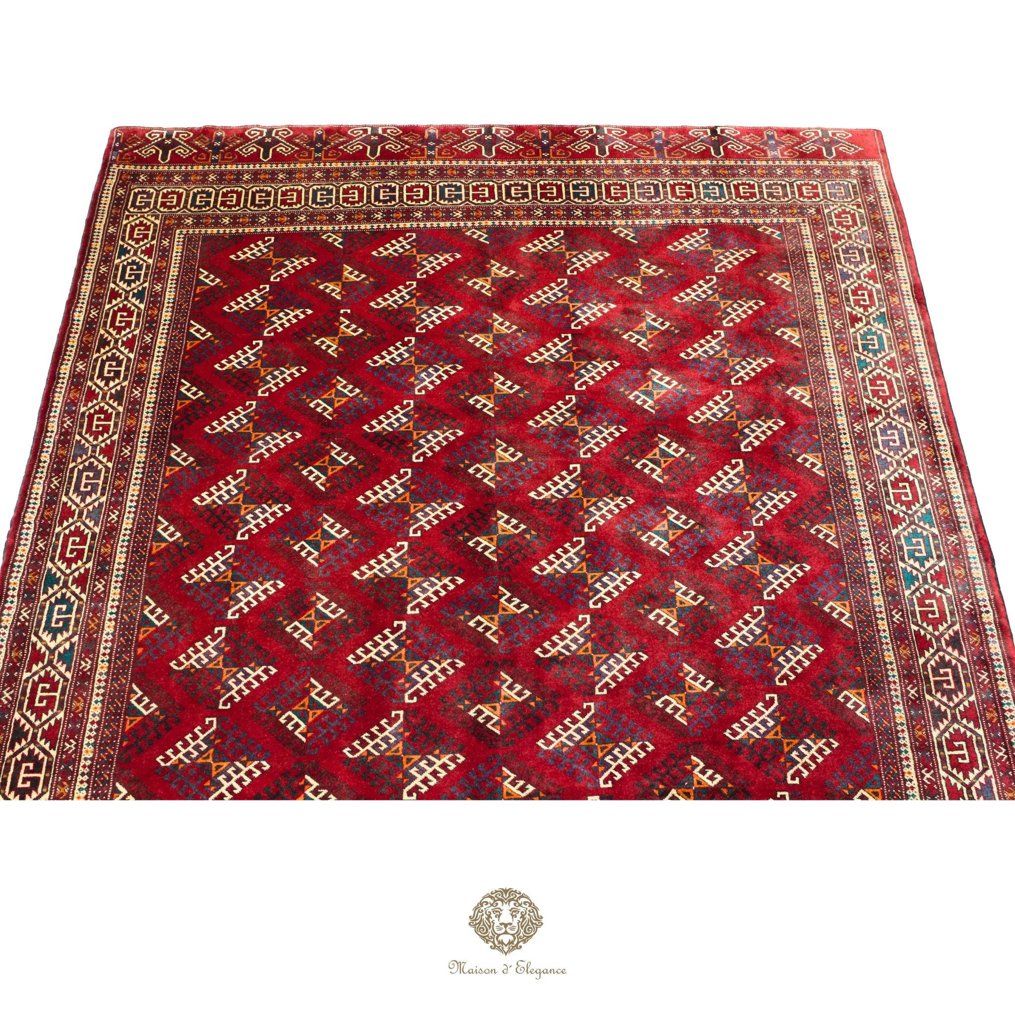 Red patterned rug with intricate designs on a red background