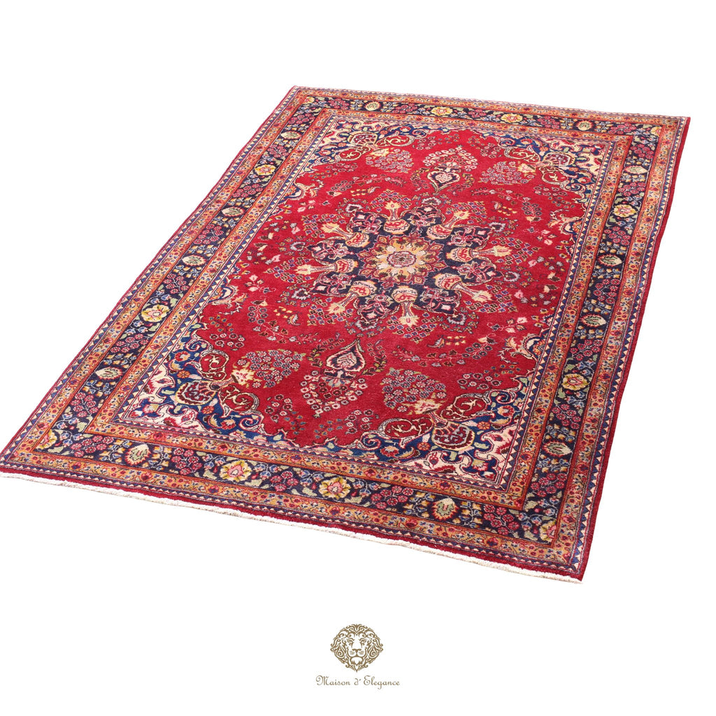 Decorative red rug with intricate patterns on a white background